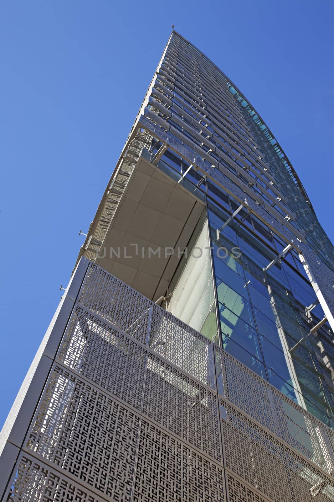 Perspective and underside angle view of modern glass building skyscrapers over blue sky 