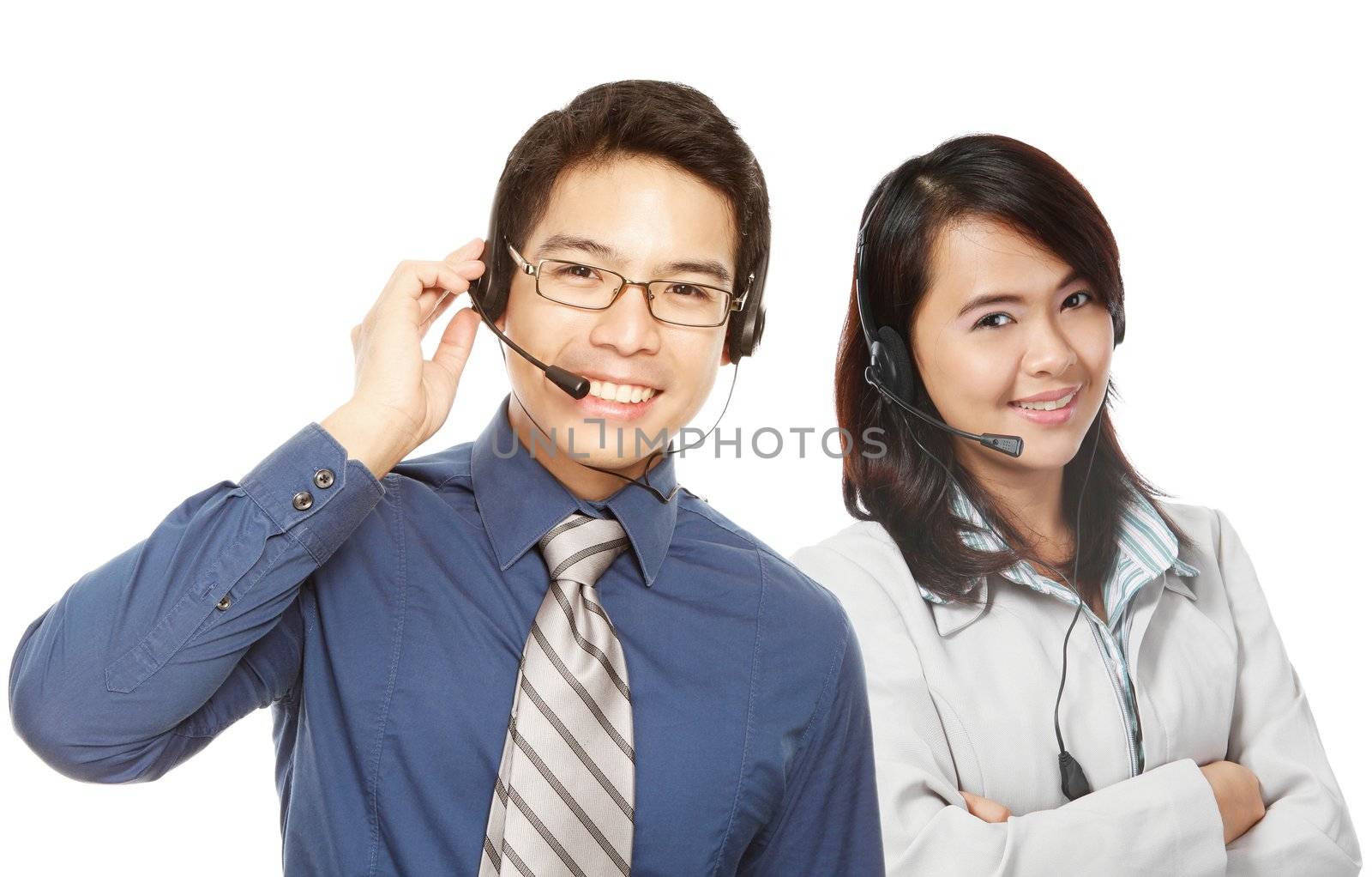 A smiling man and woman wearing headsets