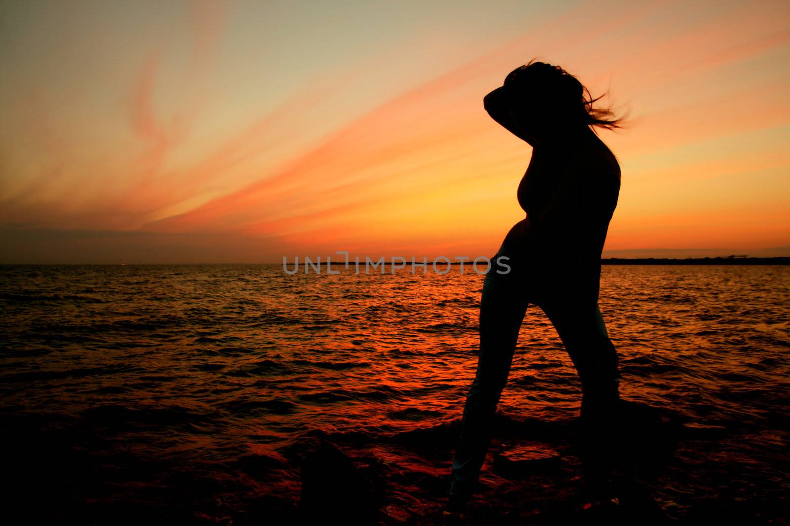 girl silhouette on sunset ocean view