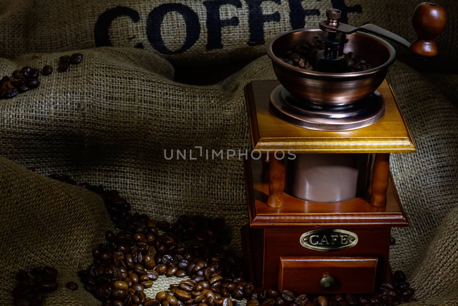 Coffee Mill with beans and burlap. still life