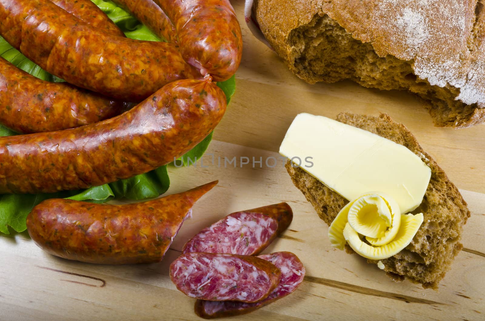 Tasty Polish sausage with bread, butter and vegetables