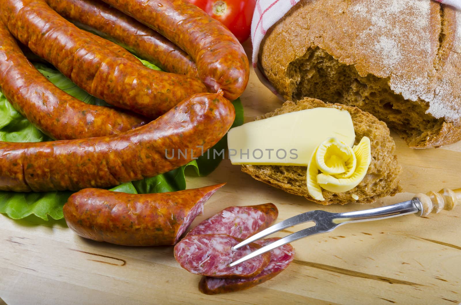 Tasty Polish sausage with bread, butter and vegetables