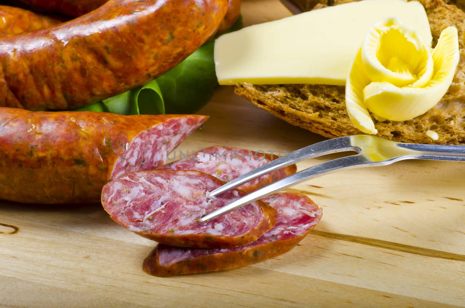 Tasty Polish sausage with bread, butter and vegetables