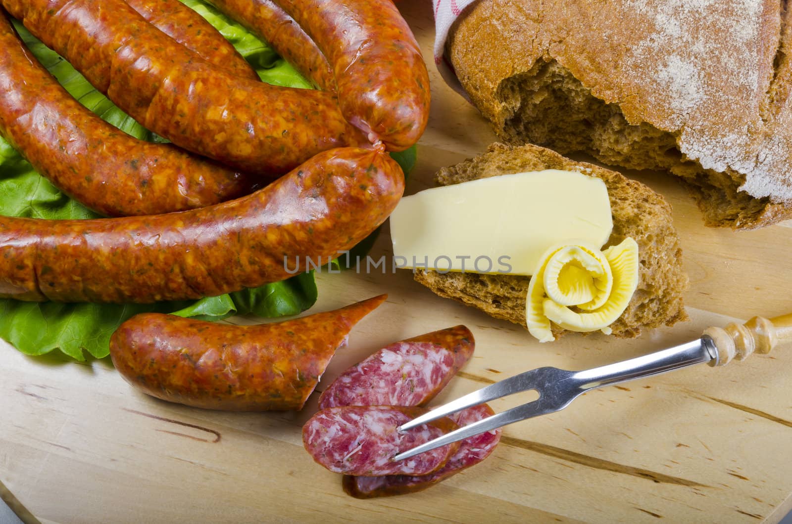 Tasty Polish sausage with bread, butter and vegetables