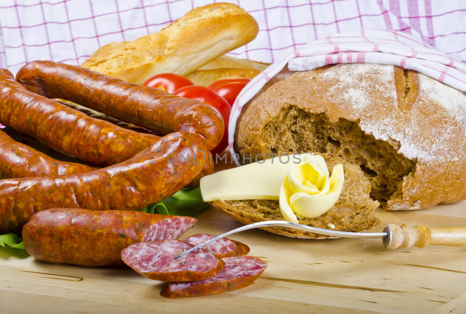 Tasty Polish sausage with bread, butter and vegetables