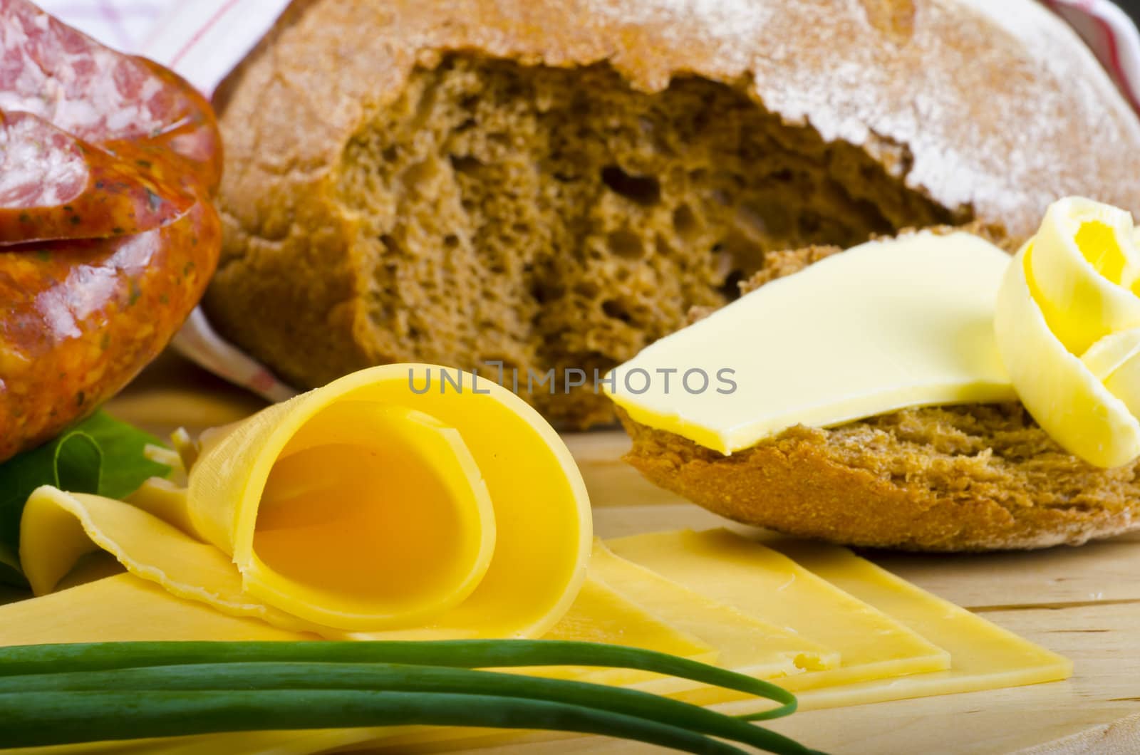 Tasty Polish sausage with bread, butter and vegetables