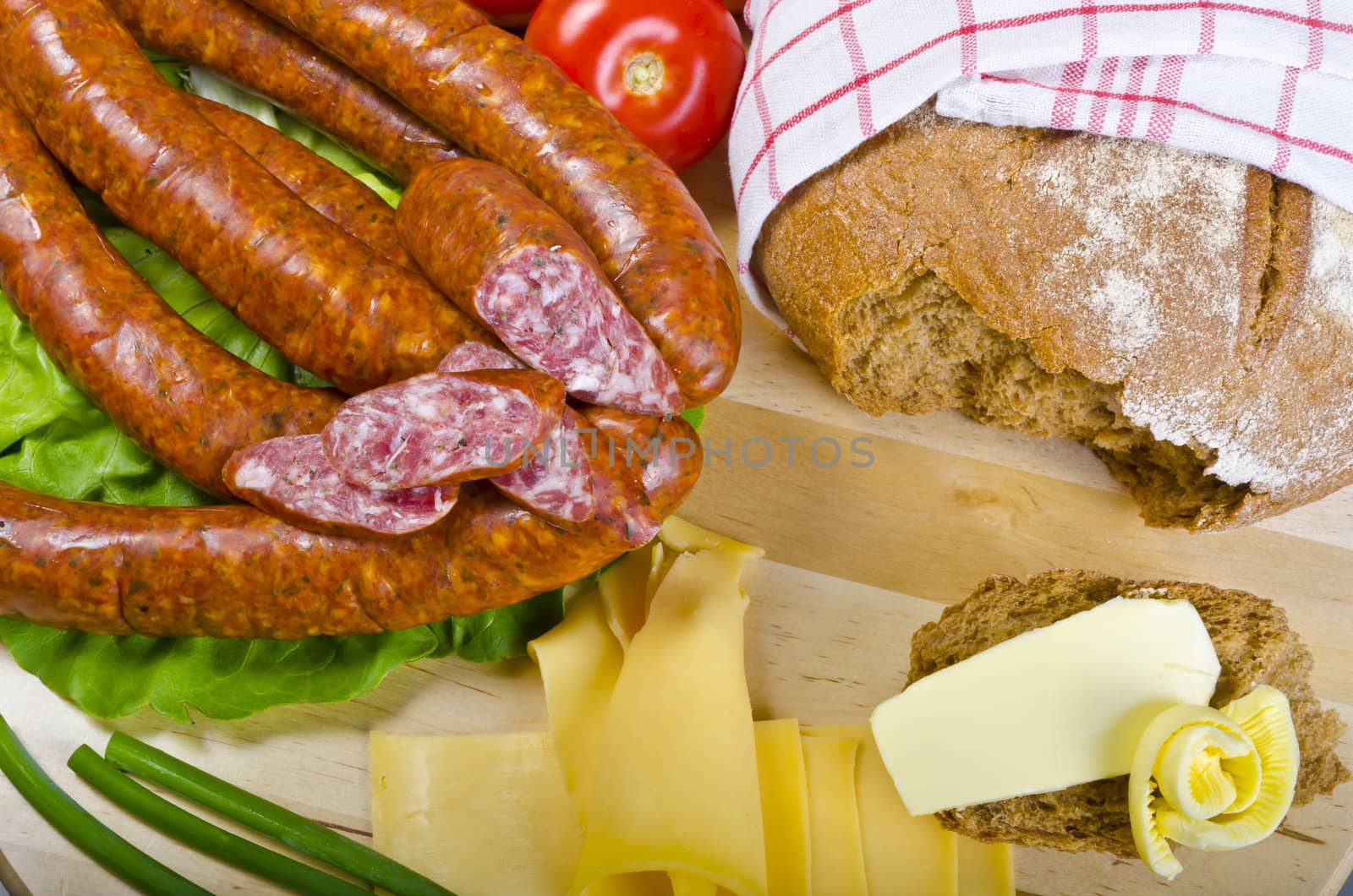 Tasty Polish sausage with bread, butter and vegetables