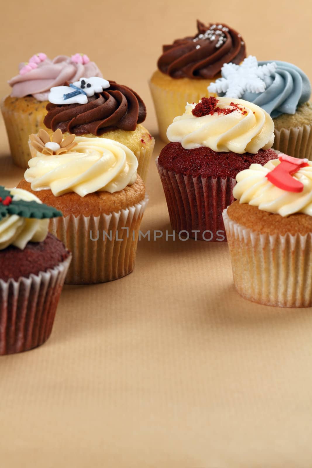 Photo of different flavoured cupcakes on a table.
