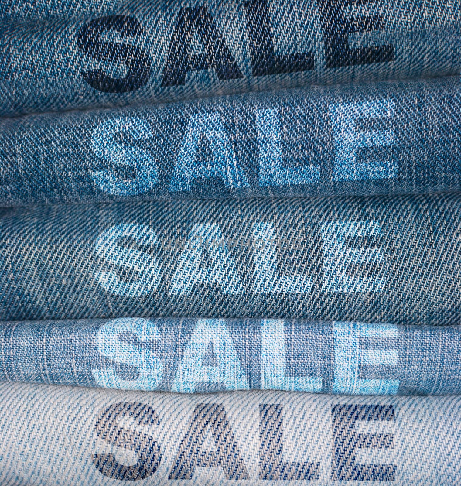 Sale Signs on Stack of Blue Jeans