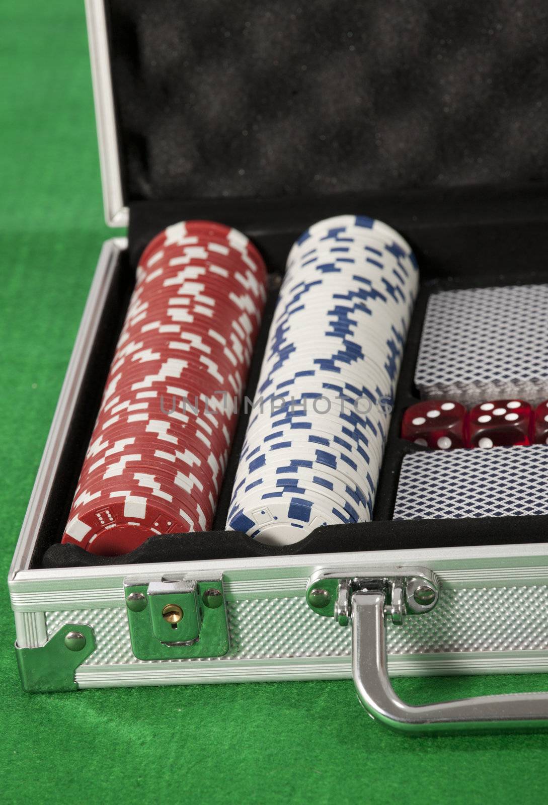 poker chips and cards in a briefcase by senkaya