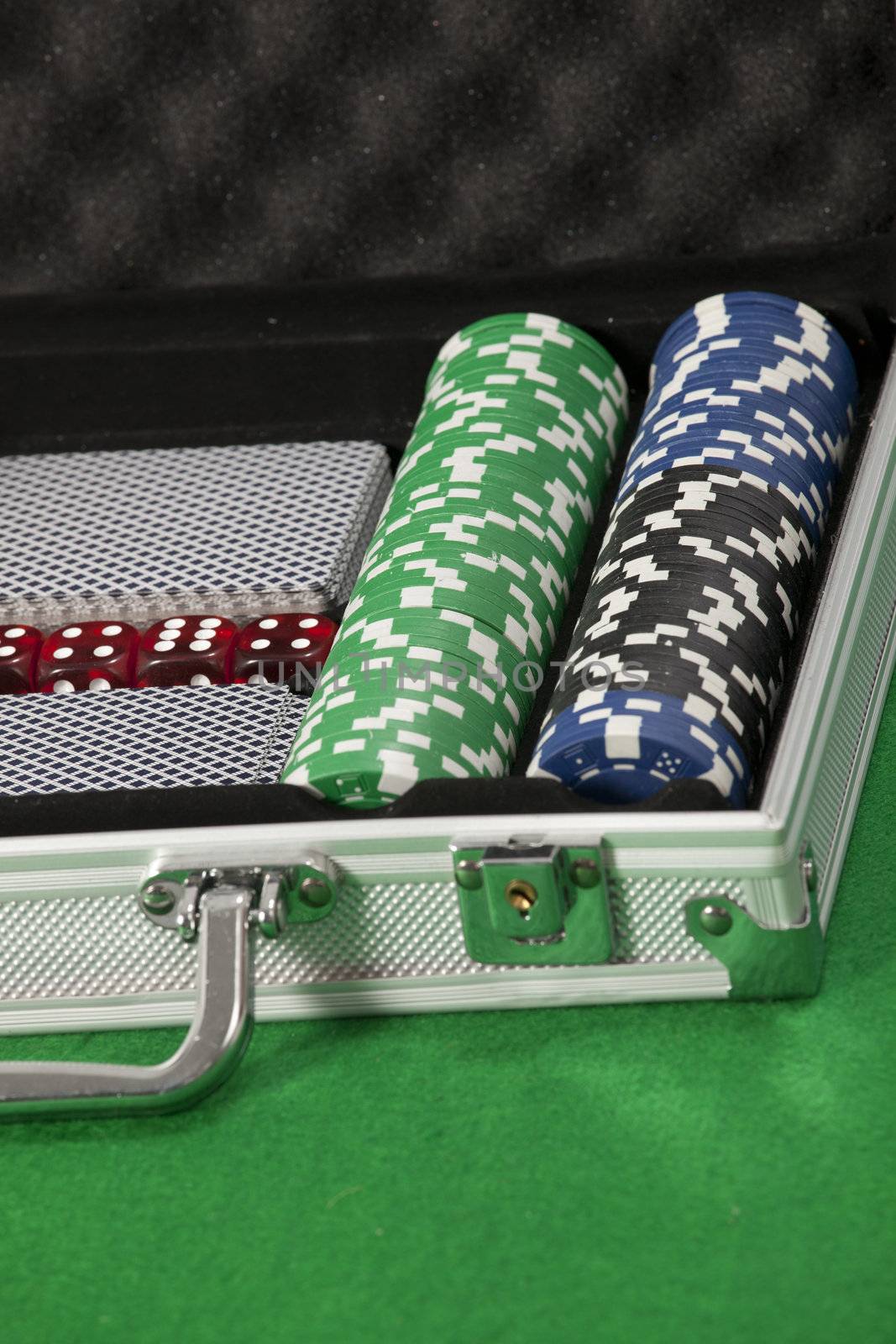 poker chips and cards in a briefcase by senkaya