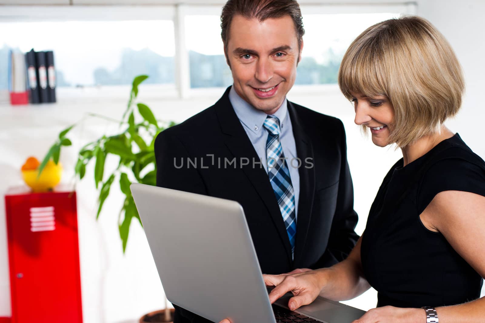 Secretary showing power point presentation to the boss by stockyimages