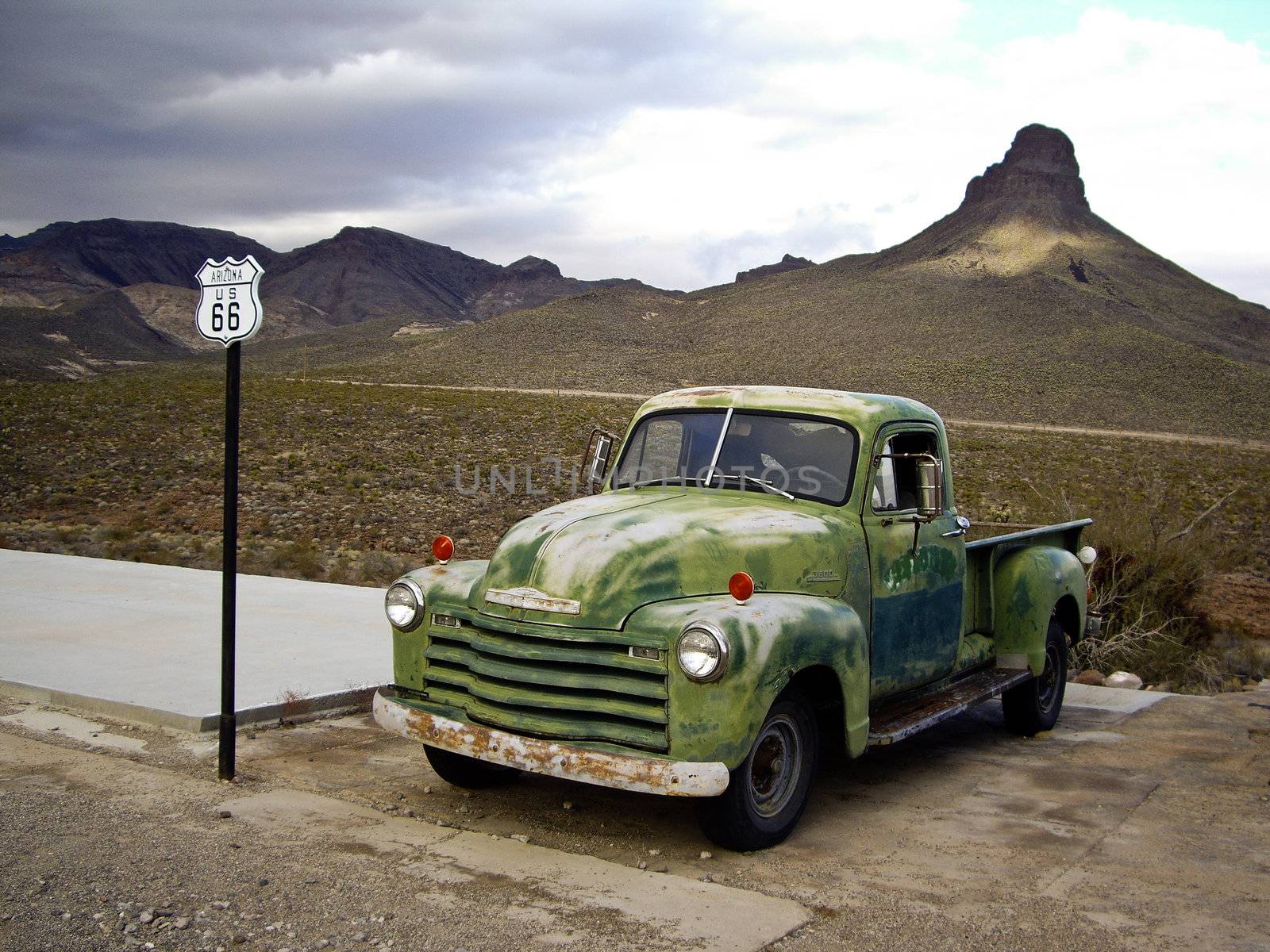 ROUTE 66, ARIZONA/USA - DECEMBER 30: Vintage green Chevrolet truck with Route 66 sign at gas station shown on December 30, 2012 in Arizona's historic Route 66