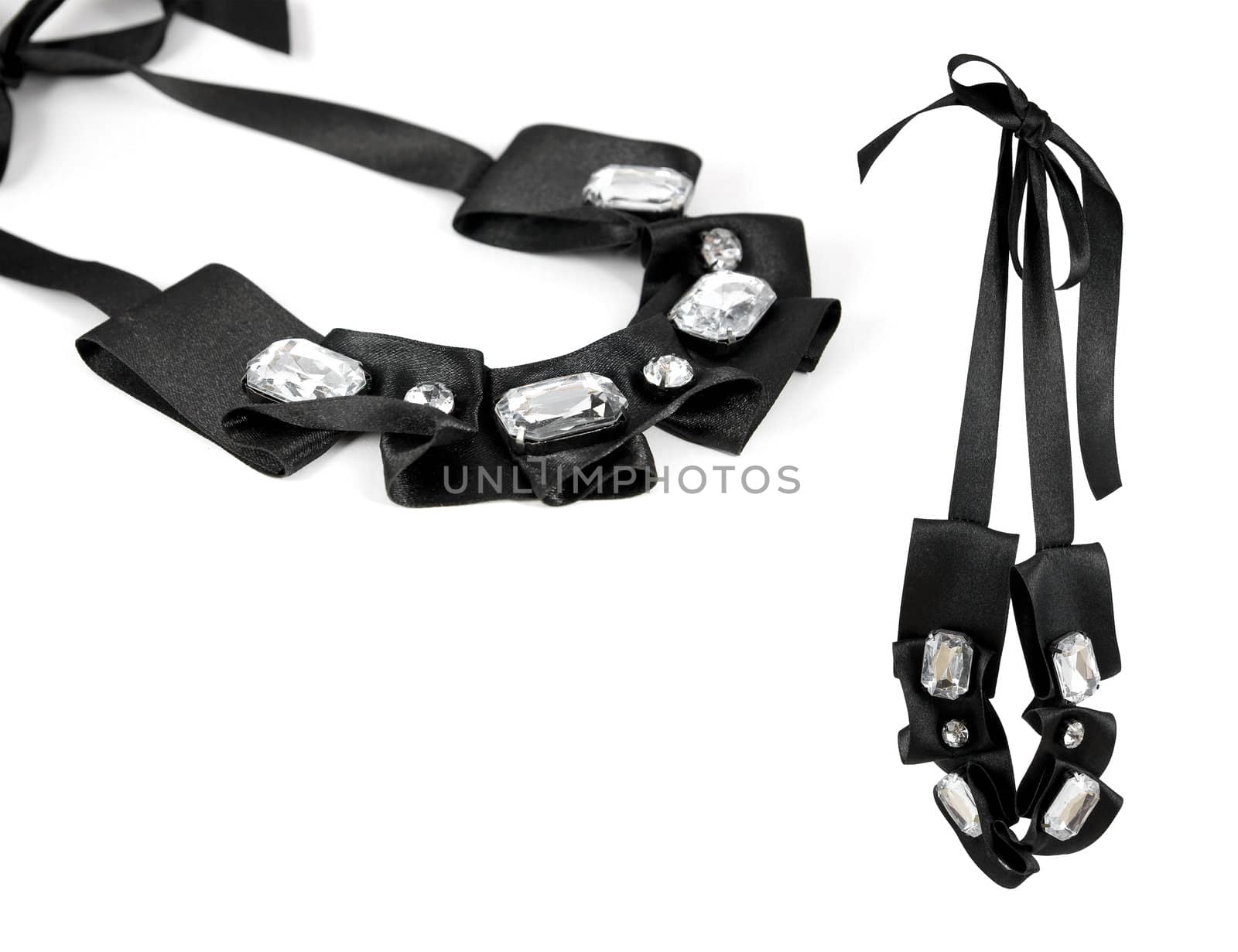 Elegant necklace with glossy glass gems on black ribbon. Isolated on white background. Copy-space.