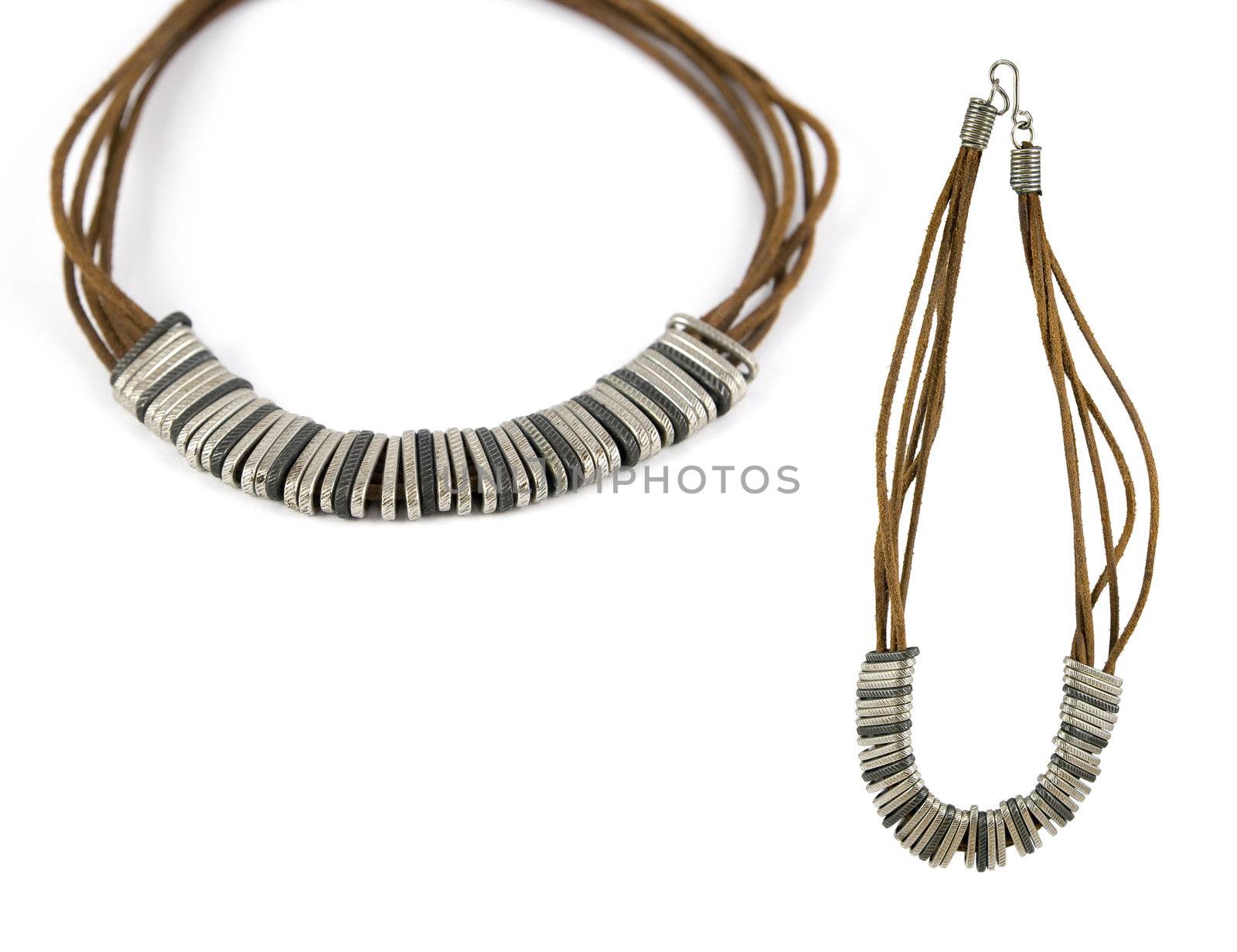 Metal pieces and raw leather stripes forming a beautiful necklace. Isolated over pure white. Copy-space.