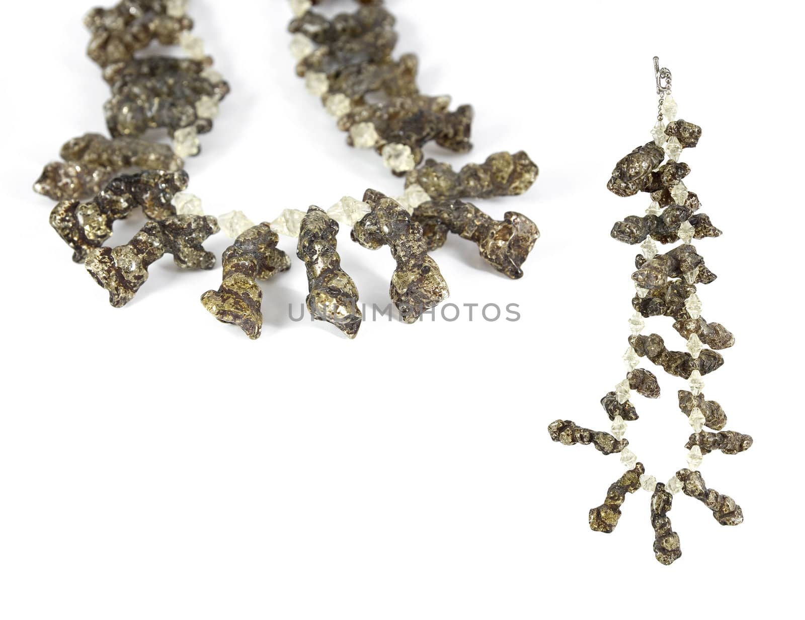 Unique necklace made from raw amber stones. Isolated on white. Copy-space.