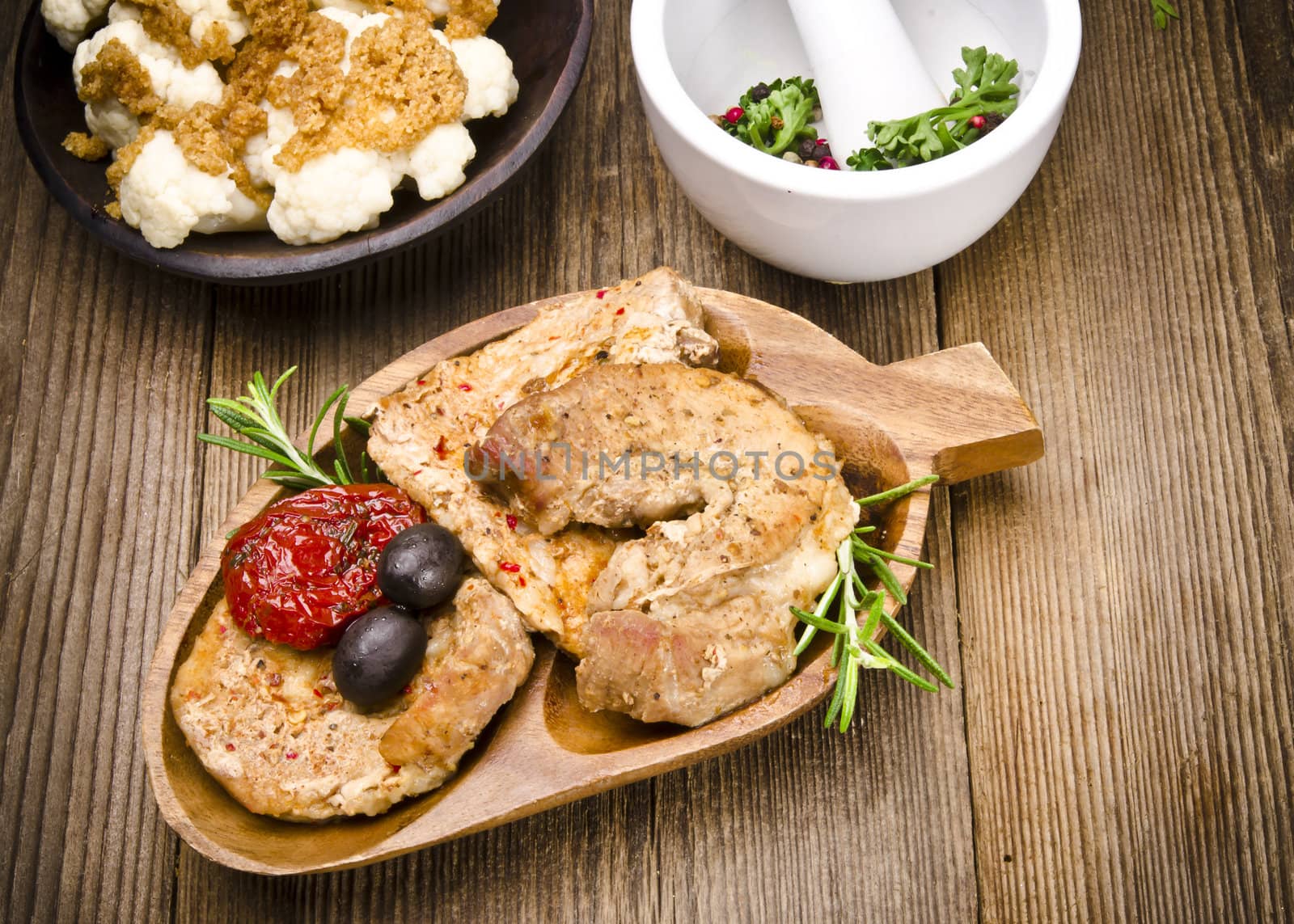 Baked meat with olives and roasted tomatoes