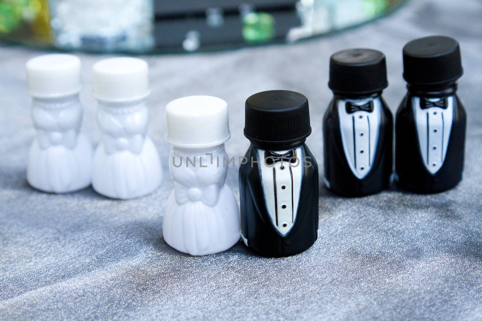 These party favors are containers of bubbles at a wedding. The photographs here represent the bridal party lined up together.
