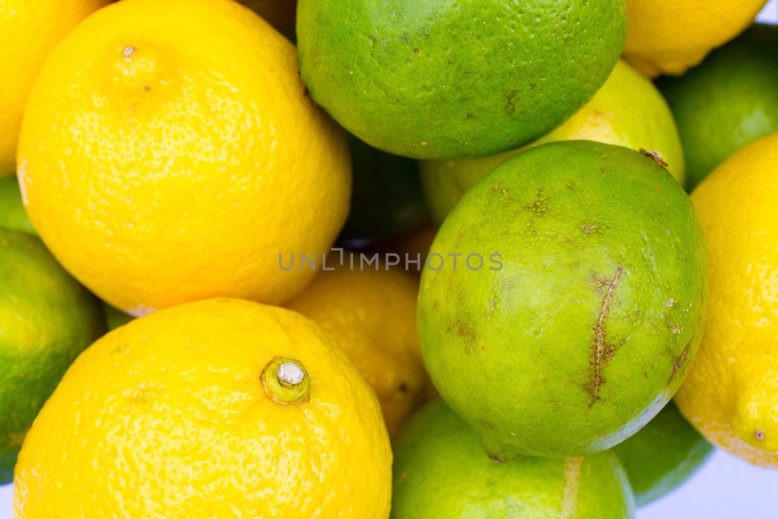 Yellow lemons sit together with green limes as fruit decor centerpieces at a wedding.