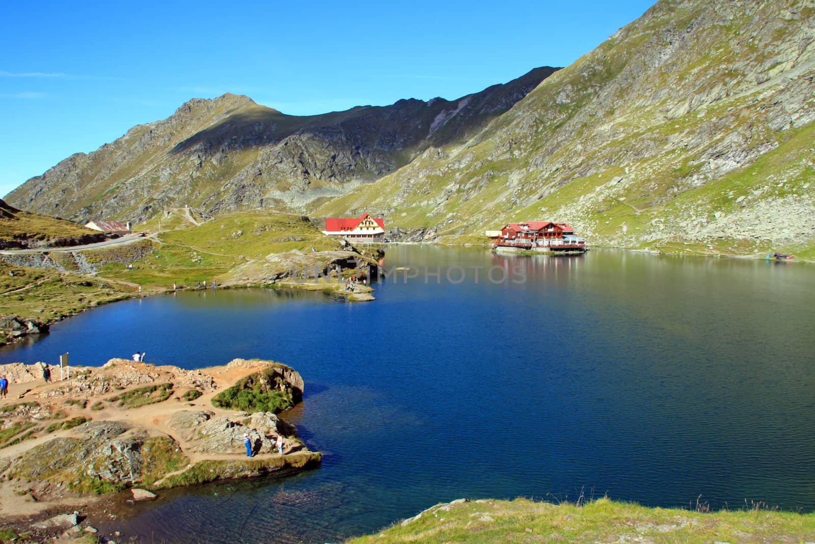 An ice-cold pond in the mountains, a vacation site nearby.