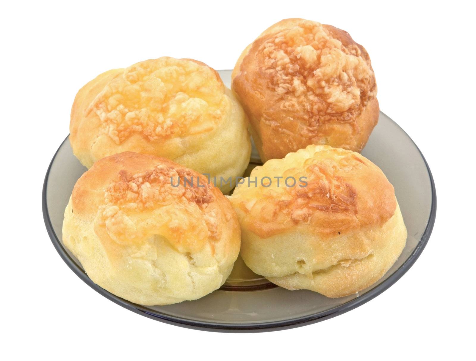 Four homemade scones on a glass plate isolated on white background