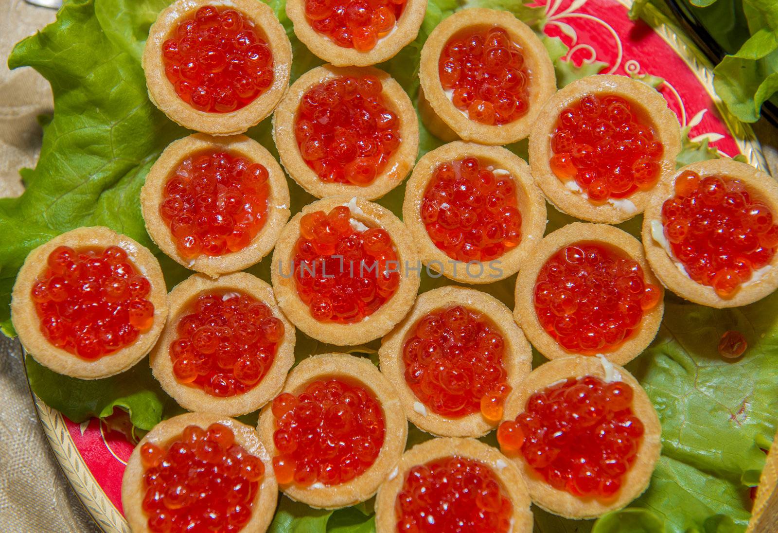The decorated tartlets with salmon red caviar