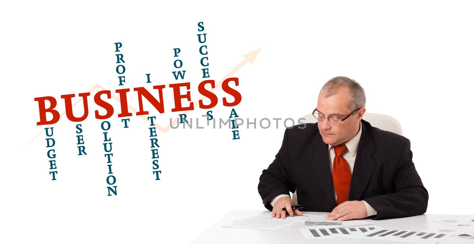 businessman sitting at desk with word cloud by ra2studio