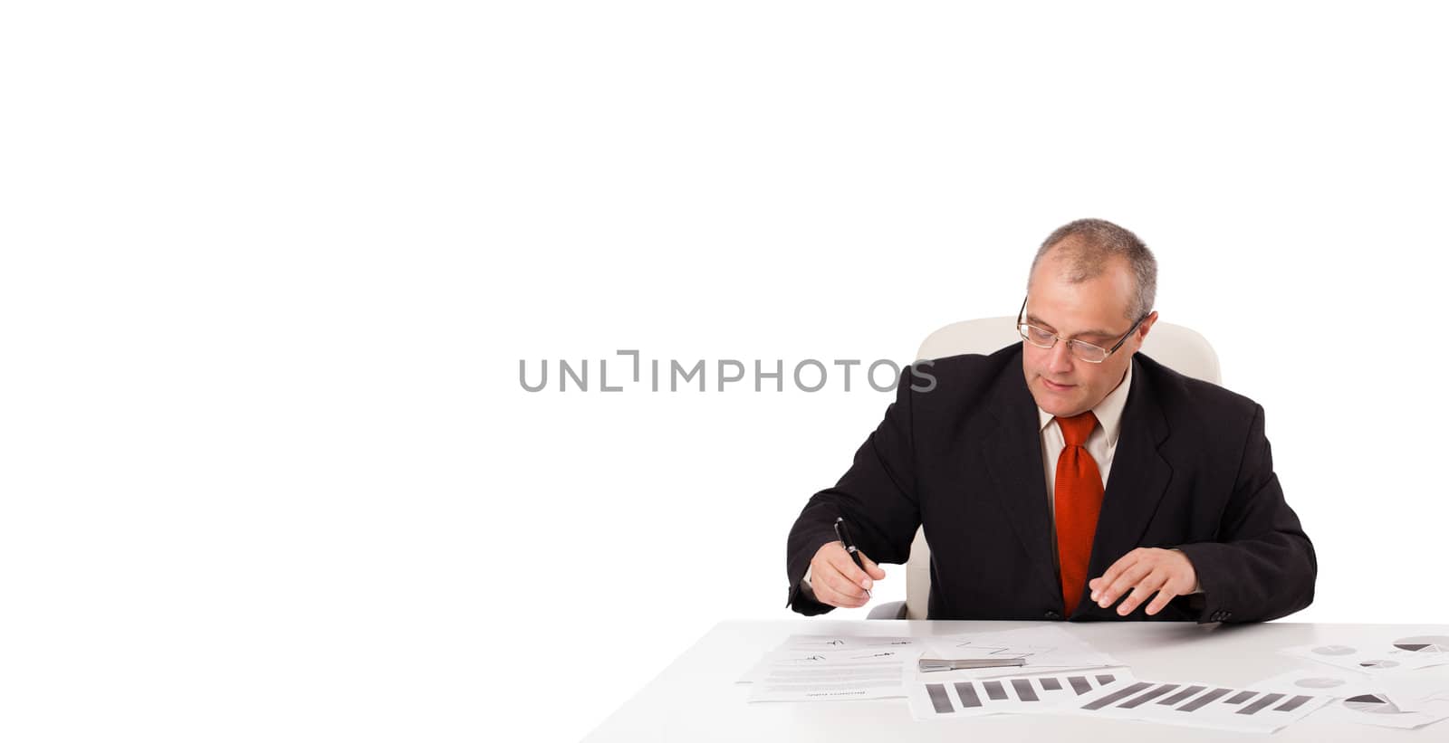 businessman sitting at desk with copy space, isolated on white