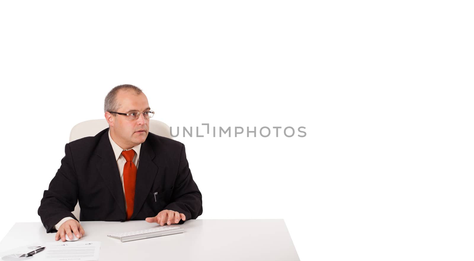 businessman sitting at desk and typing on keyboard with copy space, isolated on white