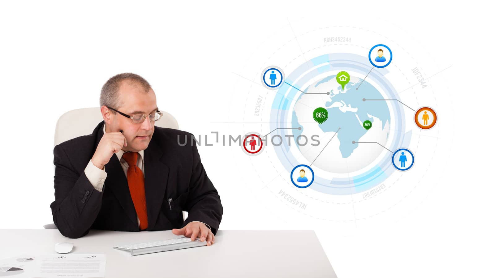 businessman sitting at desk and typing on keyboard with globe and social icons, isolated on white