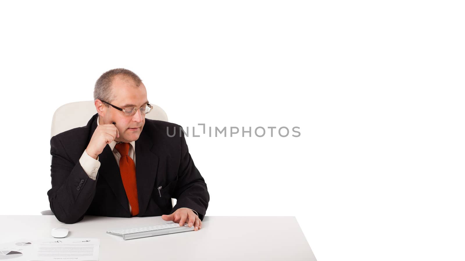 businessman sitting at desk with copy space, isolated on white