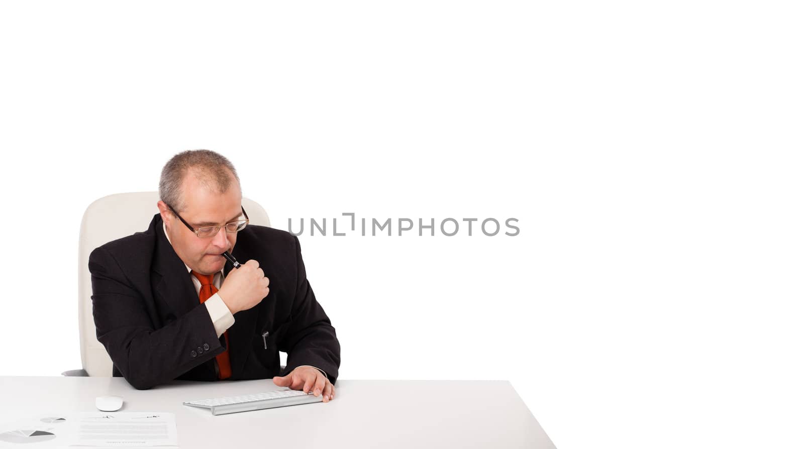 businessman sitting at desk with copy space, isolated on white