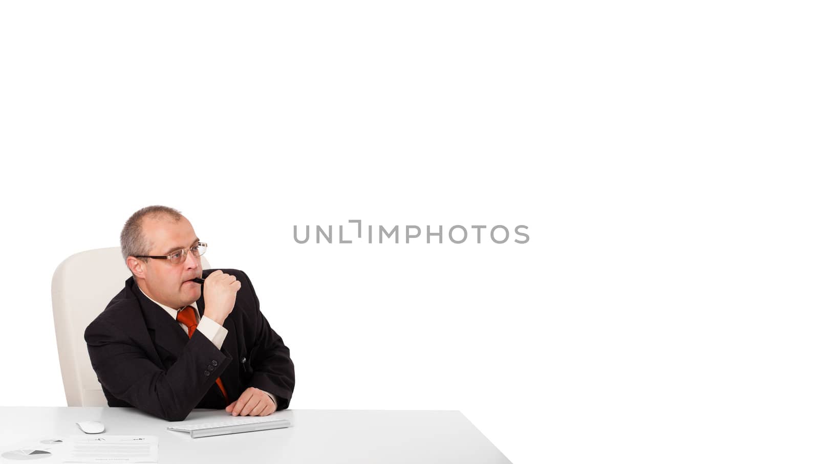 businessman sitting at desk with copy space, isolated on white