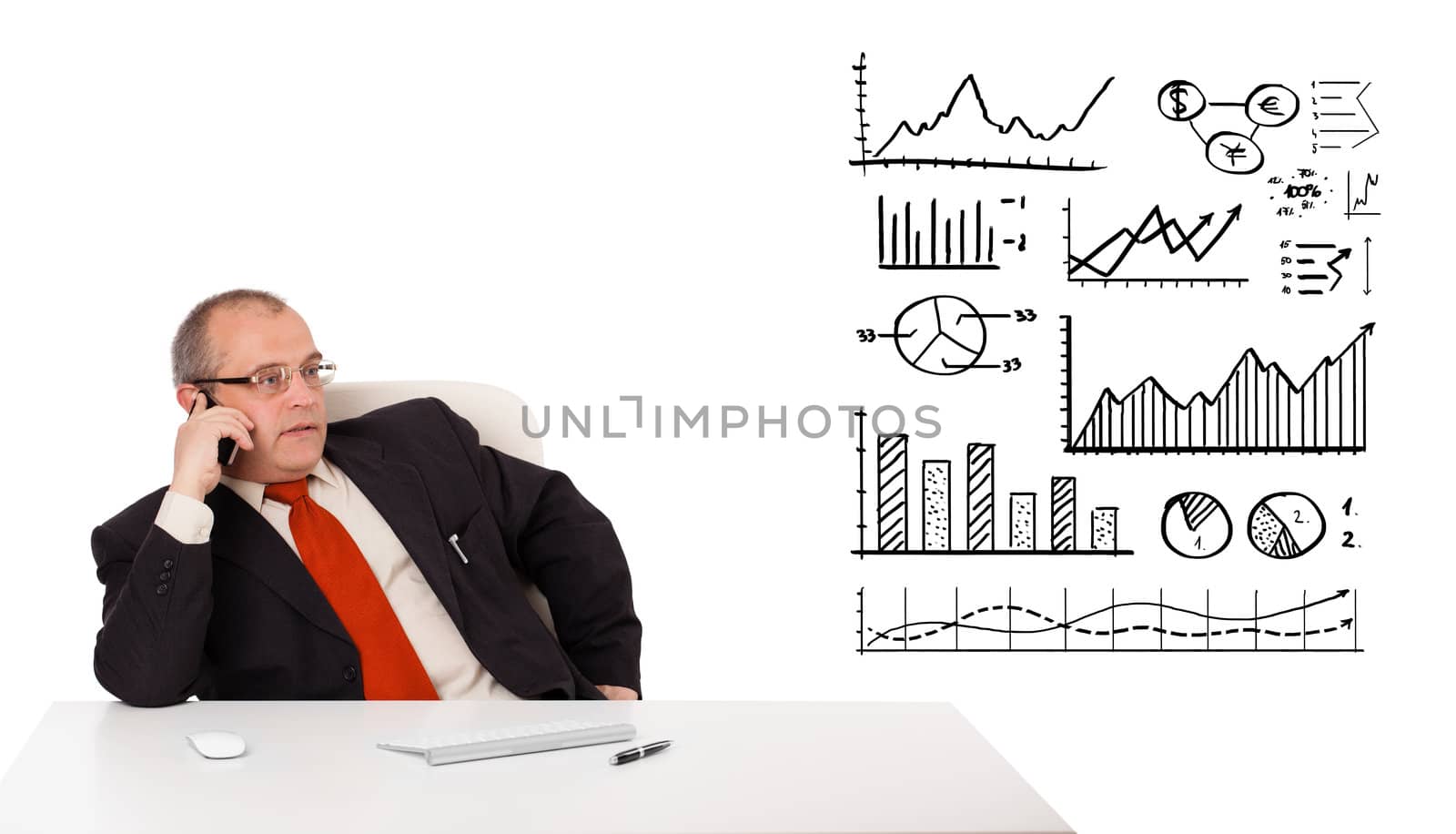 Businessman sitting at desk with diagrams and making a phone call, isolated on white