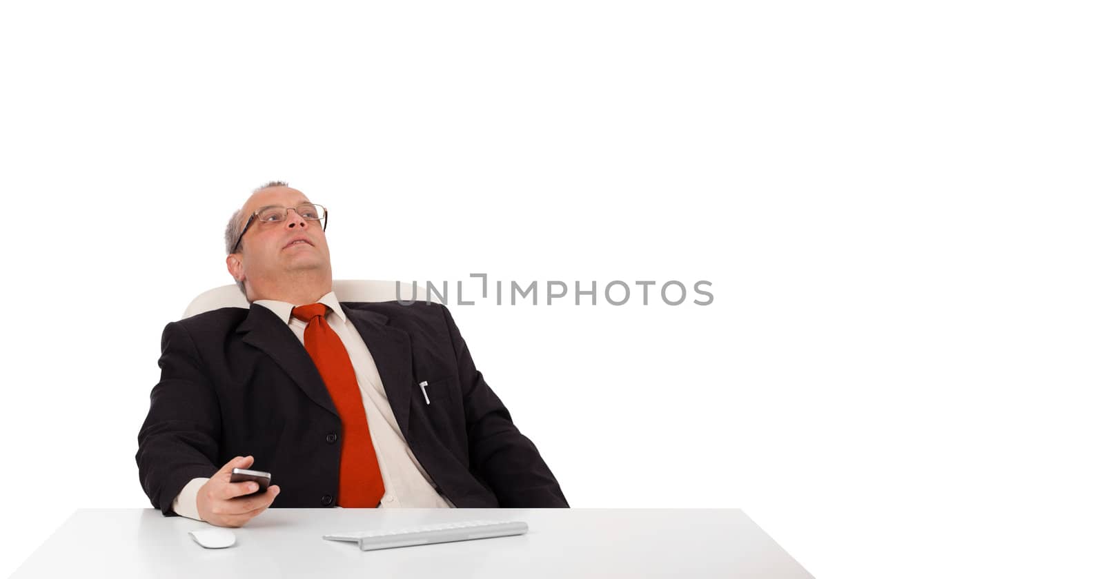 businessman sitting at desk and holding a mobilephone with copys pace, isolated on white