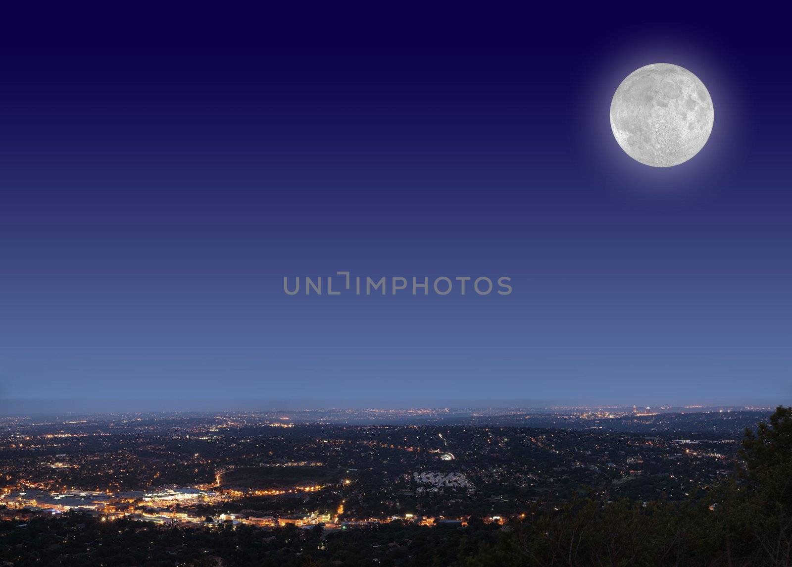 Johannesburg night cityscape with big bright moon on blue black sky by alistaircotton