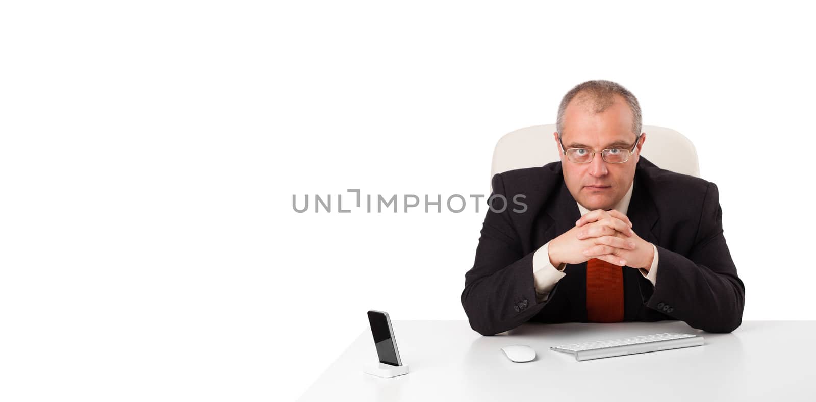 businessman sitting at desk with copy space, isolated on white