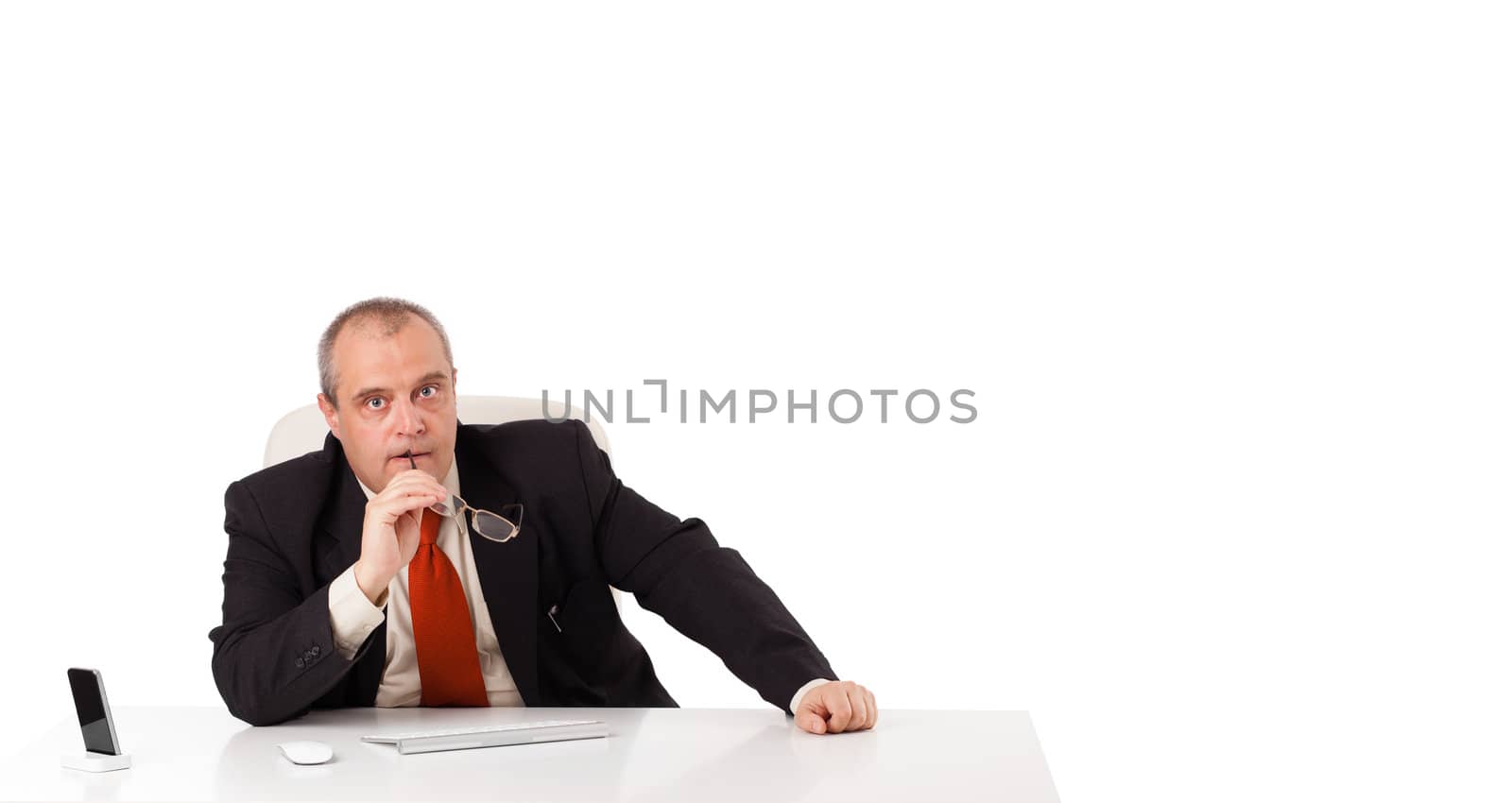 businessman sitting at desk with copy space, isolated on white