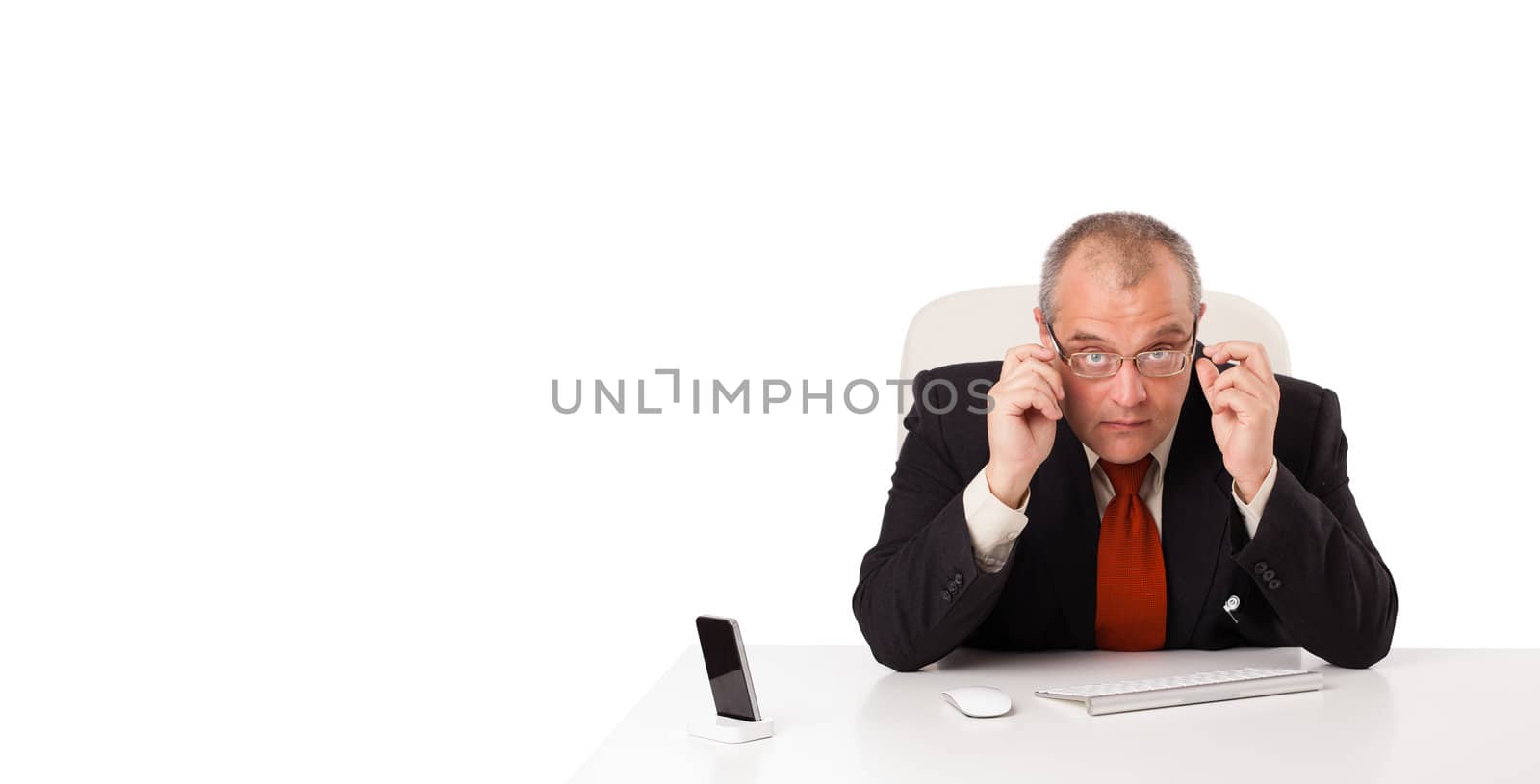 businessman sitting at desk with copy space, isolated on white