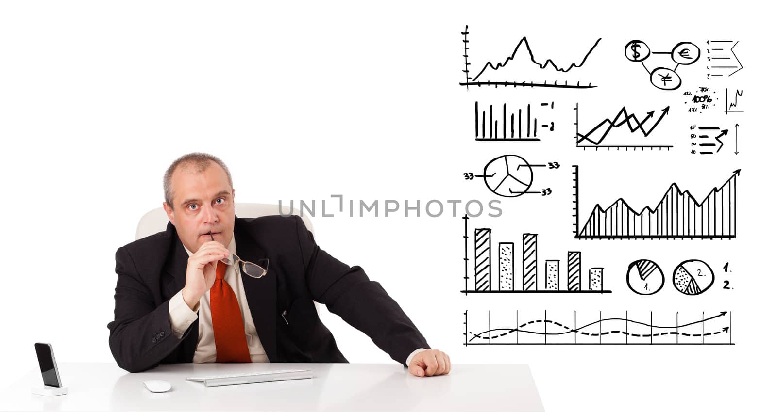 Businessman sitting at desk with diagrams and graphs, isolated on white