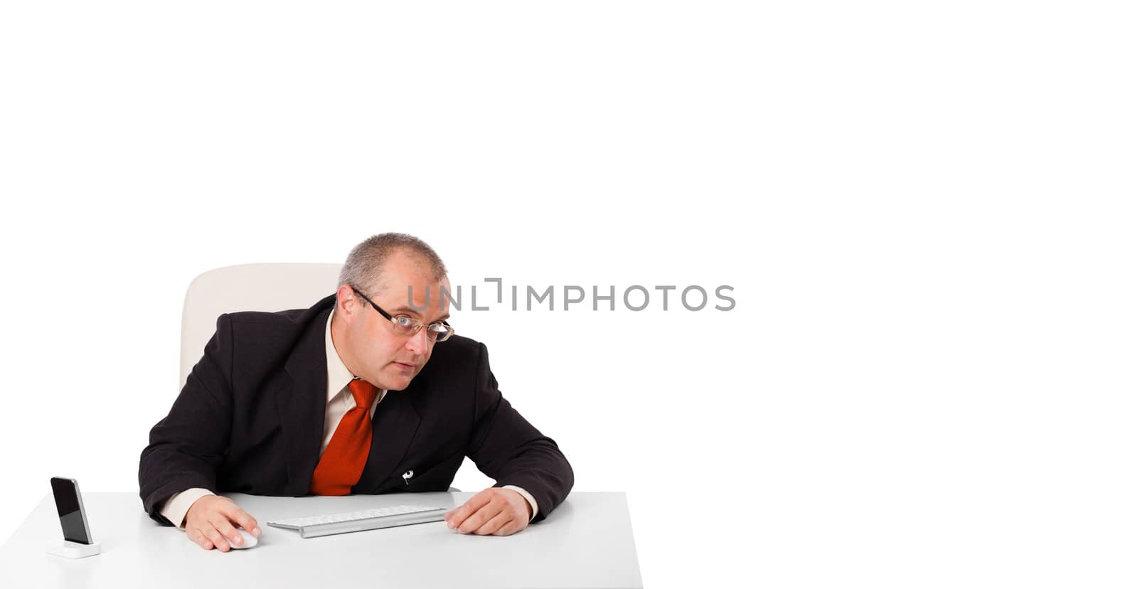 businessman sitting at desk with copy space, isolated on white