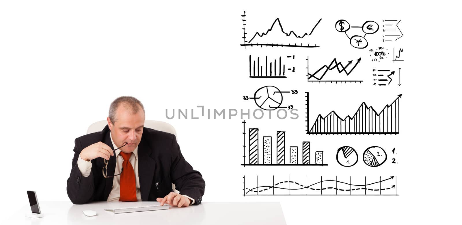 Businessman sitting at desk with diagrams and graphs, isolated on white