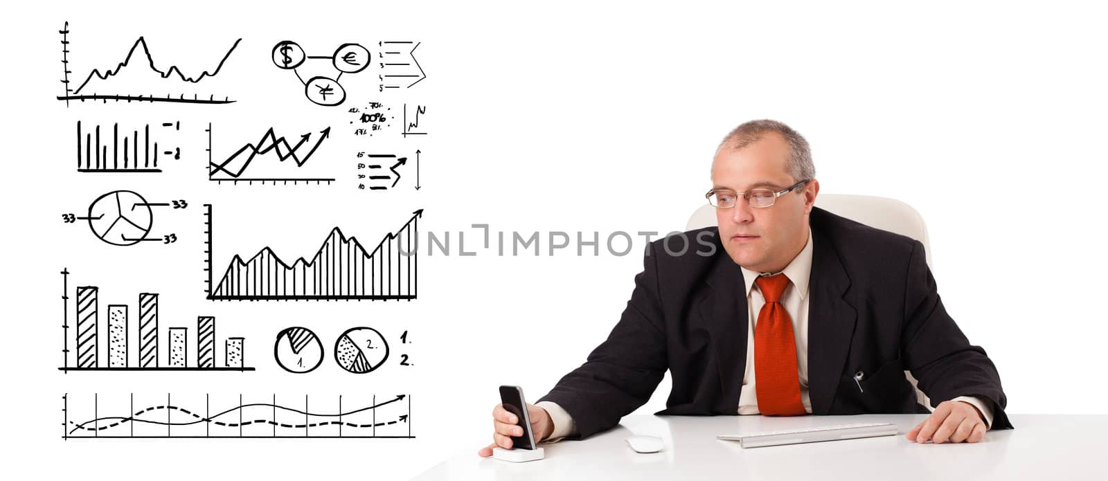 Businessman sitting at desk with diagrams and graphs, isolated on white