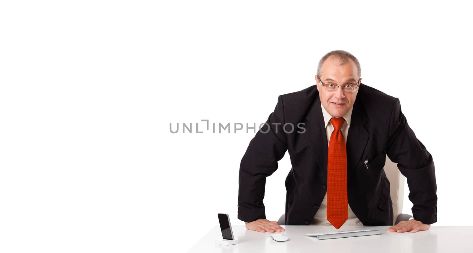 businessman sitting at desk with copy space, isolated on white