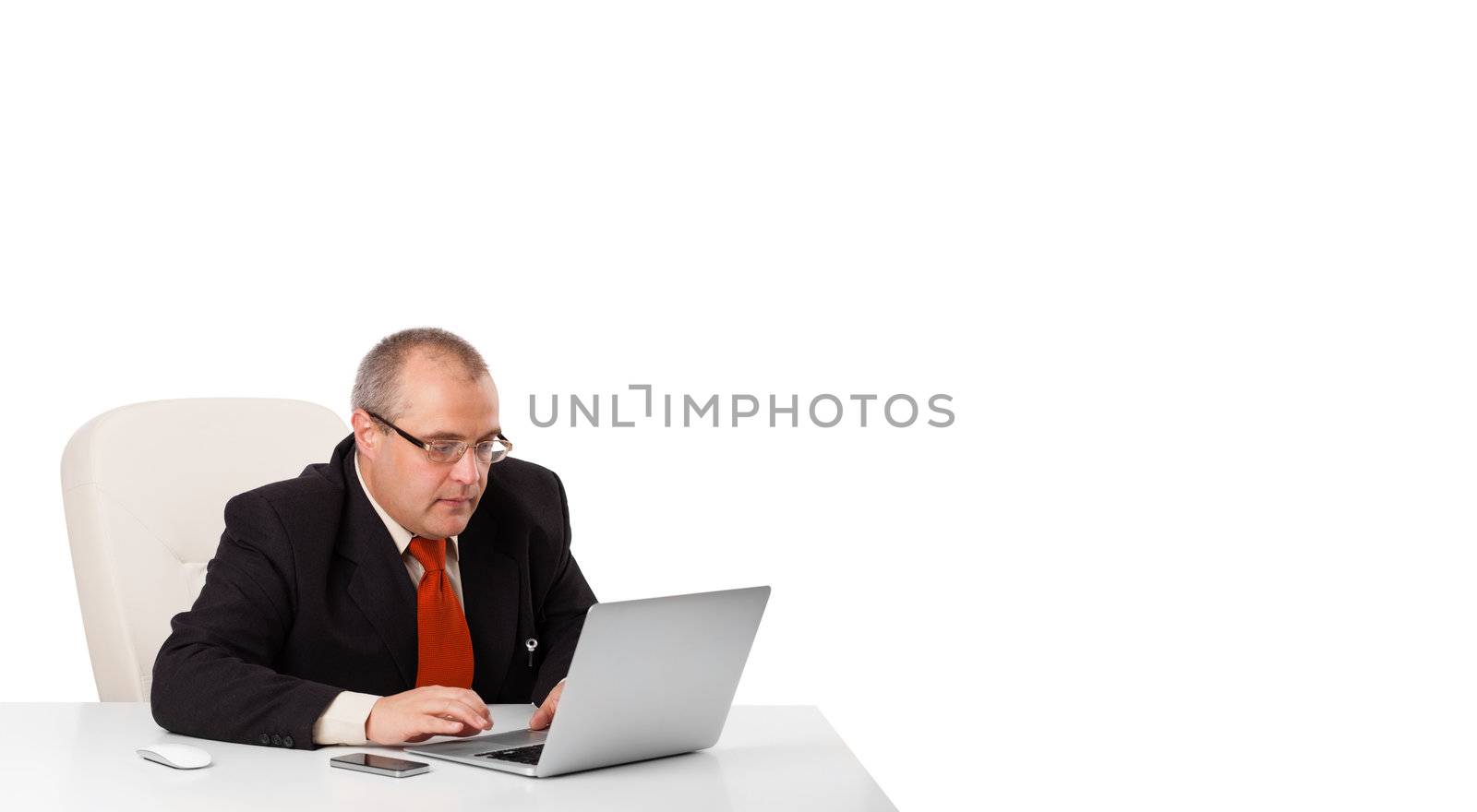 buisnessman sitting at desk and looking laptop with copy space, isolated on white