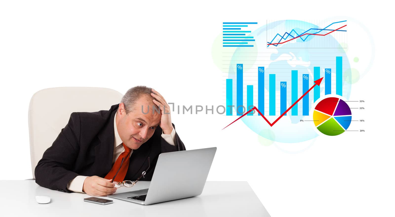 Businessman sitting at desk with laptop and statistics, isolated on white