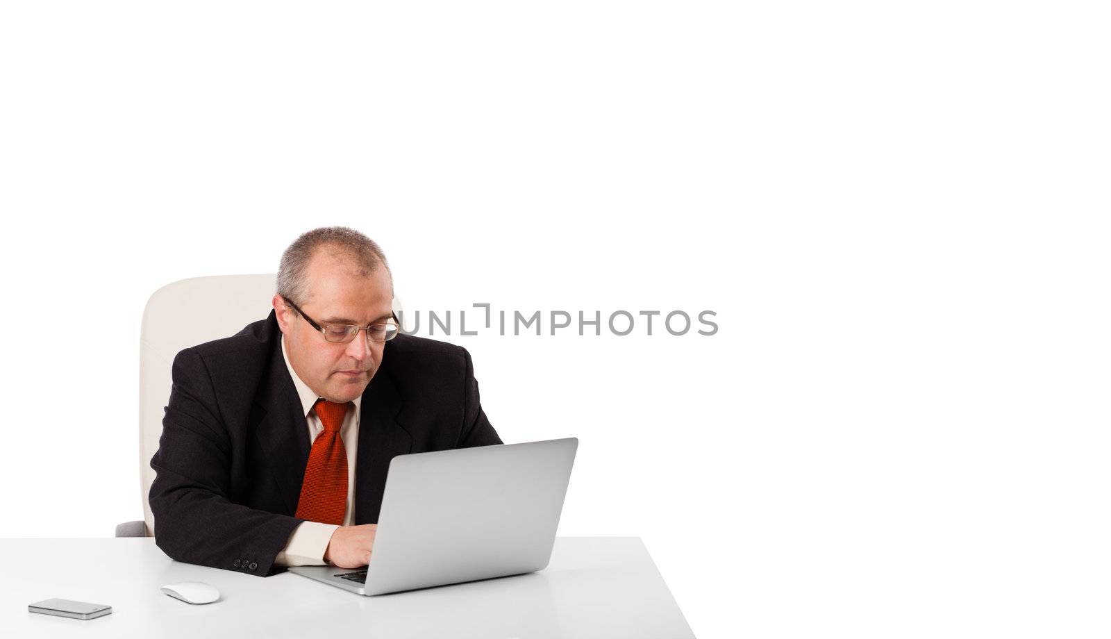 buisnessman sitting at desk and looking laptop with copy space, isolated on white
