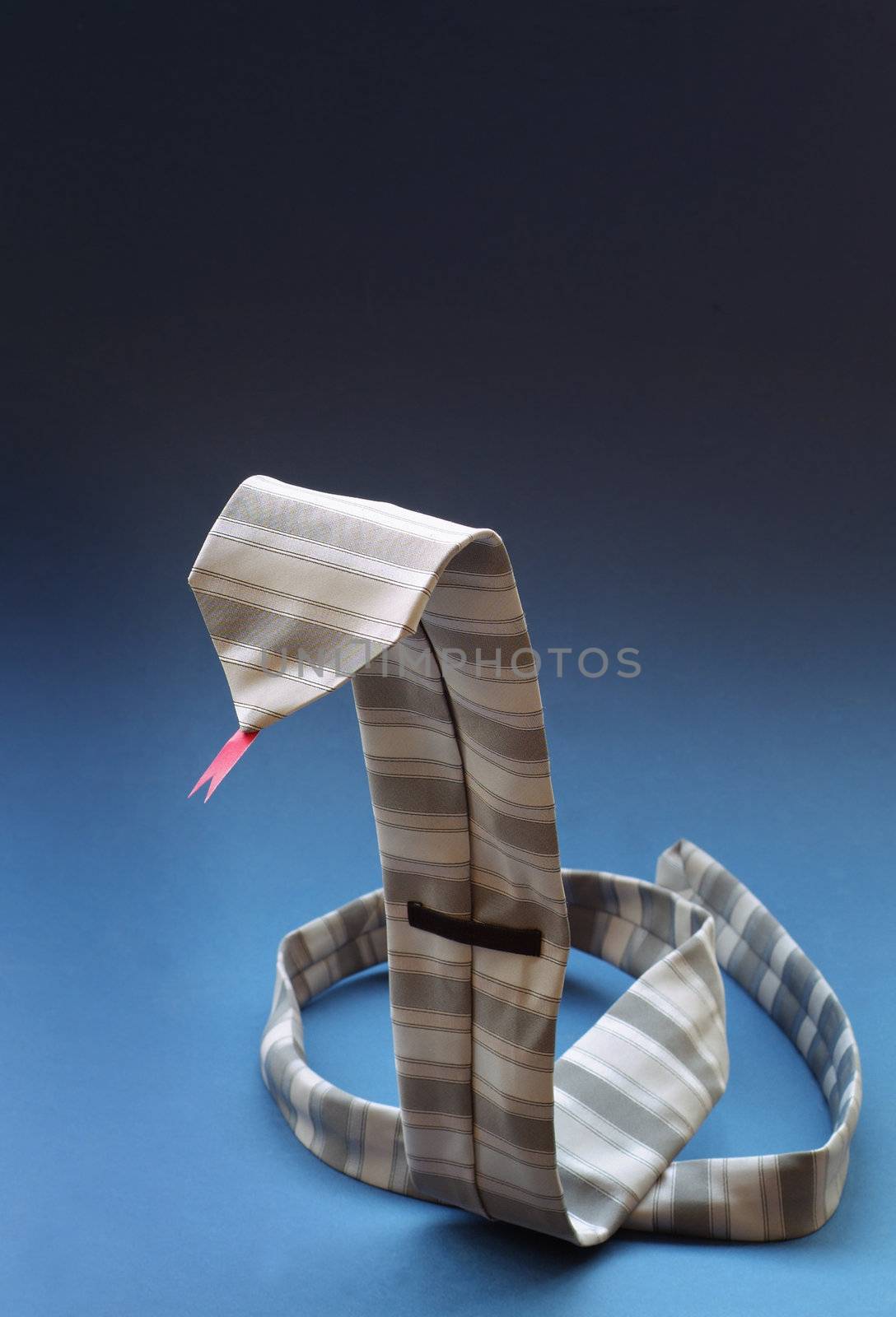 Business mans tie in the shape of a snake with a red tongue on blue background