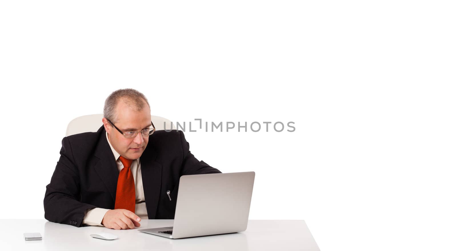 buisnessman sitting at desk and looking laptop with copy space, isolated on white