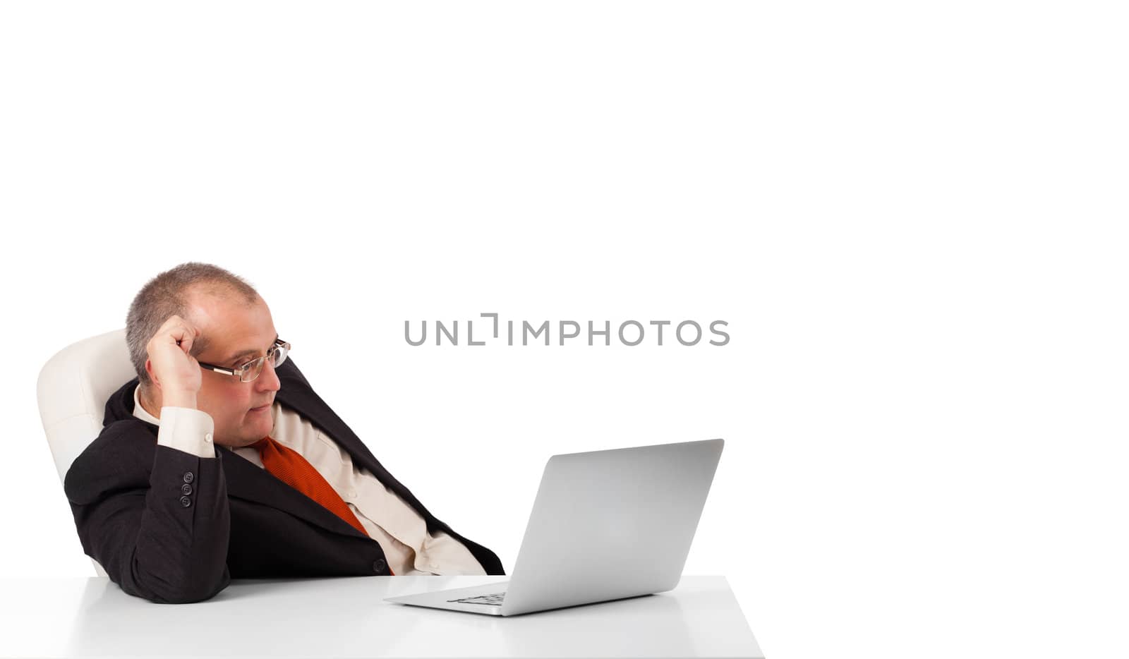 buisnessman sitting at desk and looking laptop with copy space, isolated on white